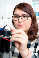 Teenage girl working on CNC machinery.