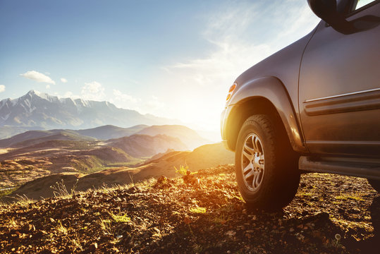 Big 4x4 Car Against Sunset And Mountains