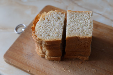 Slices of toast bread on wooden table, top view