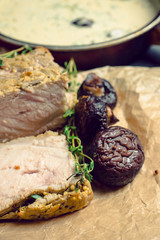 Roasted meat with mushrooms and sauce. Selective focus.