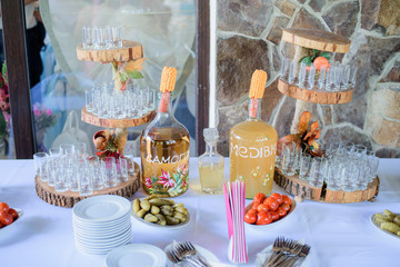 Wooden dishes with shots for alcohol stand on dinner table