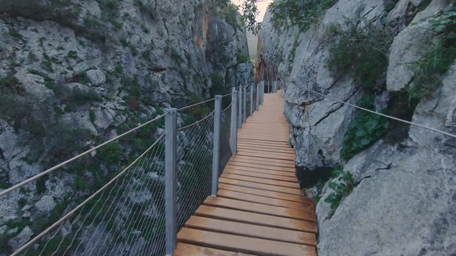 Slow motion POV shot of traveler explore amazing travel destination, inspiring others for adventure, new year best place to visit. dangerous and adrenaline rush on wooden bridge in mountains