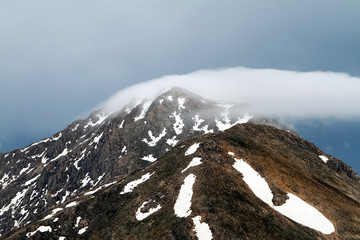 Spring views of the snowy mountains of the Turkey. Formation of clouds over mountains peaks.