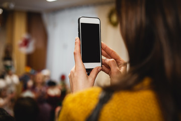 Girl's hand holding mobile phone take a photo