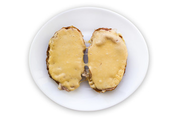 Disgusting sandwiches lying on a white plate. Unhealthy breakfast.