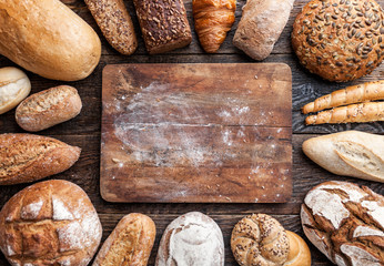 Delicious fresh bread on wooden background