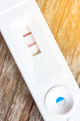 Pregnancy test  on wooden background.