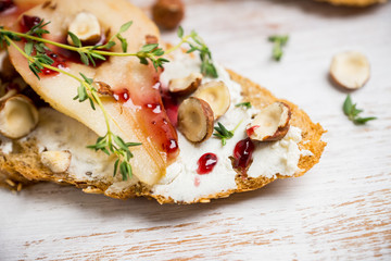 Bread with ricotta cheese and pears on the wooden background. Shallow depth of field.