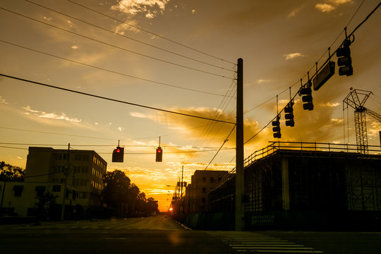 American City Street Crossing At Sunset With Red Traffic Light In Los Angeles