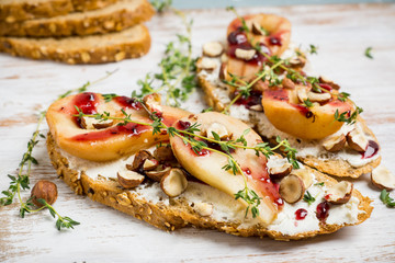 Bread with ricotta cheese and pears on the wooden background. Shallow depth of field.