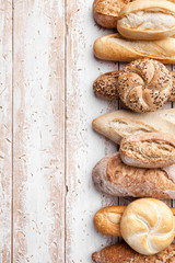 Delicious fresh bread on wooden background