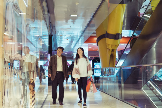 Japanese Grandfather and granddaughter shopping in Arena Barcelona  mall