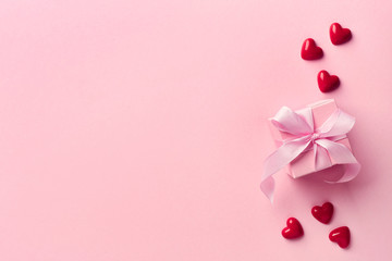 Pink gift box and red hearts