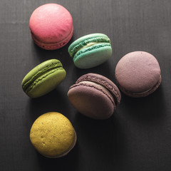 multicolored macaroon on a dark wooden table