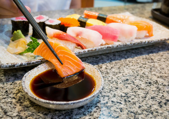 close up sushi sashimi set with chopsticks and soy sauce