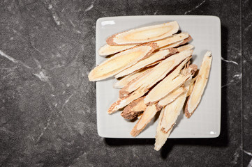 Chinese herbal medicines -- Astragalus on stone background
