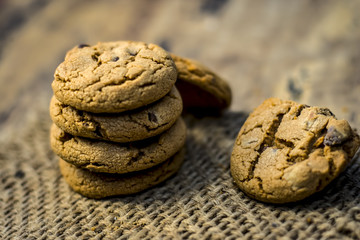 Homemade freshly baked chocolate chip cookies on gunny background.;