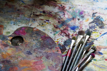 workplace painter palette with colors and brushes. Palette of colors, creative disorder, art