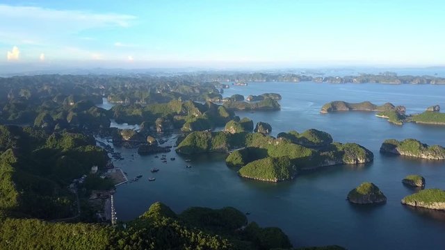Drone View Road around Island against Quiet Bay with Boats