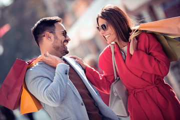 Young smiling couple shopping in the city