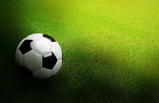 3D Rendered black and white soccer ball on green soccer football field background