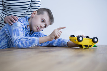 Kid playing yellow toy
