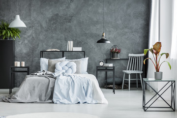 Monochromatic bedroom interior with plant