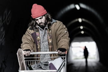 Hopeless drifter with trolley