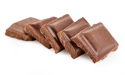 Milk chocolate pieces isolated on white background.