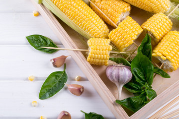Raw Organic Yellow Corn on the Cob with hot chili pepper garlic and herbs. Mexican Corn