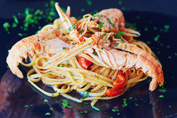 Delicious pasta with lobsters, vegetables and sauce
