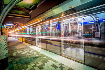 Charlotte City Skyline night scene with light rail system lynx train
