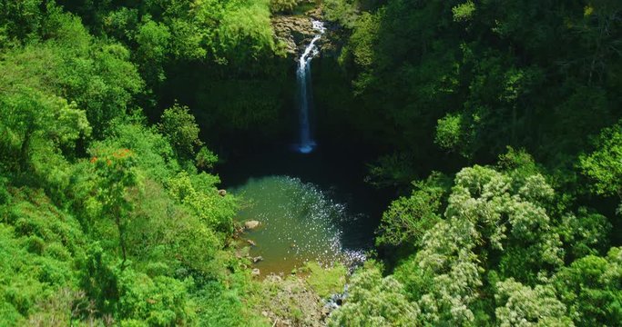 Cinematic aerial view of beautiful waterfall in Hawaii