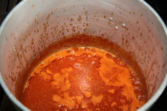 Tomato meat sauce cooking in a large pot