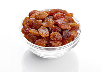 bowl of raisins on a white background. Dried grapes.