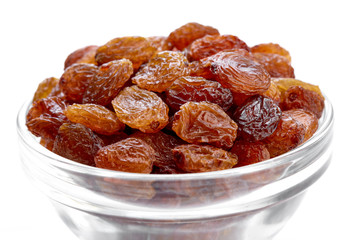 bowl of raisins on a white background. Dried grapes.