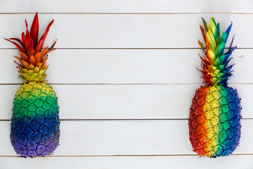 Two artistic rainbow colored painted pineapples