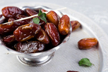 Dry fruit dates on silver tray. Copy space.