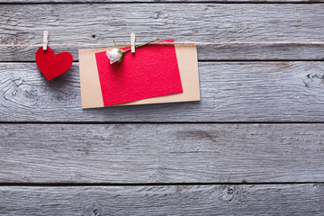 Valentine day, paper heart and card on wood background