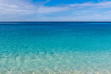 Crystal blue sea waters and blue sky. Myrtos beach on Kefalonia island. Greece