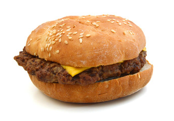 Cheeseburger and Mustard in sesame seeded bun isolated on white from overhead.
