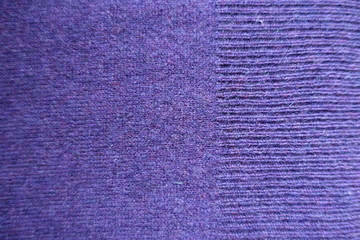 Ribbing on the edge of plain knit stitch violet fabric
