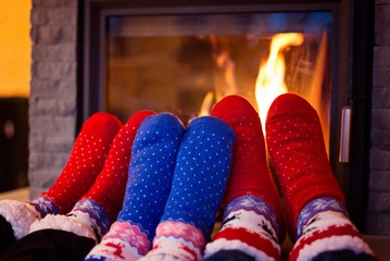 Family in woolen sock warming feet