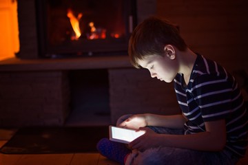 Fototapeta na wymiar Eight years old boy using digital tablet