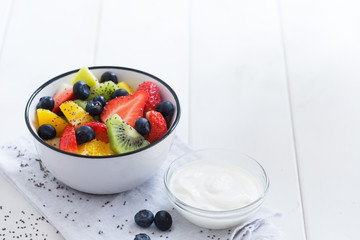 Fresh organic fruit salad with chia seeds and yogurt