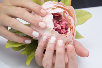 Beautiful natural nails and attractive manicure on women hands.