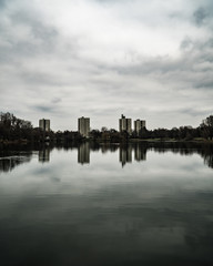 The Lerchenauer Lake in Munich on a cloudy day in fall and with silky smooth water surface