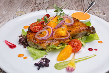 Fried chicken leg on a white plate