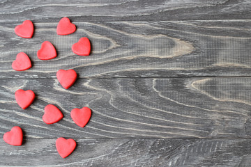 Valentine's Day . Red hearts on a wooden background.