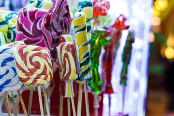 Colorful candies, jellies, lollipops, marshmallows and marmalade in a glass jars .